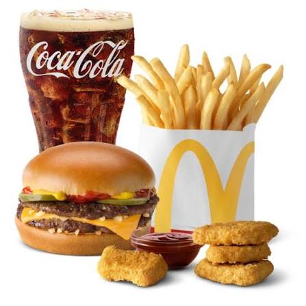clean modern fast food dining area with yellow and red accent booths, wooden tables, and bright overhead lighting at Mcdonalds